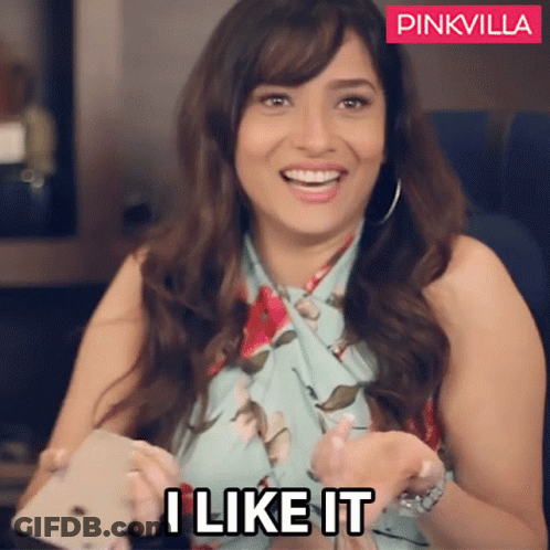 A Woman Is Smiling And Holding A Cell Phone With The Words " I Like It " On The Bottom GIF