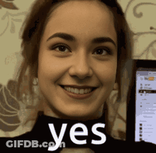 Smiling Woman Holding Yes Sign GIF