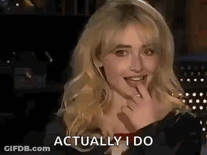 A Woman Is Smiling And Holding Her Hand To Her Mouth While Talking . GIF