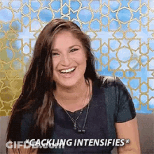 A Woman Is Smiling And Laughing With The Words `` Cackling Intensifies '' Written On The Bottom Of Her Face . GIF