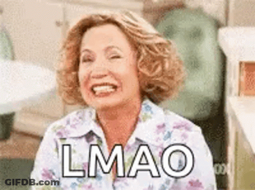 A Woman Is Smiling And Laughing With The Words `` Lmao '' Written On Her Face . GIF