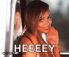A Woman Is Smiling And Looking Out Of A Car Window With The Words Heeeey Written On It . GIF