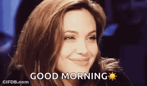 A Woman Is Smiling And Saying `` Good Morning '' With A Sun In The Background . GIF