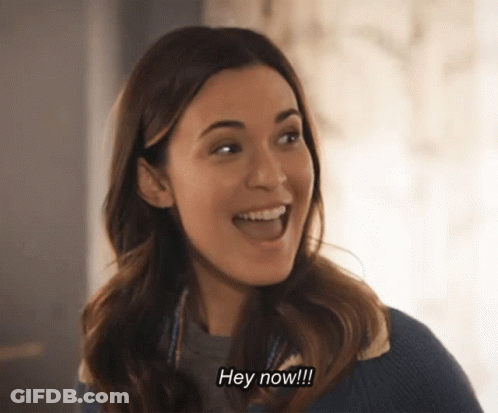 A Woman Is Smiling And Saying Hey Now !!! GIF