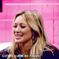 A Woman Is Smiling And Saying I 'M So Happy ! GIF