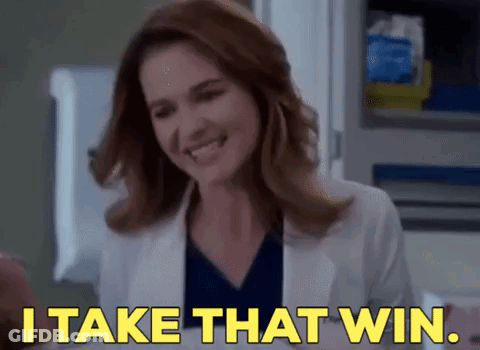 A Woman Is Smiling And Saying `` I Take That Win '' . GIF
