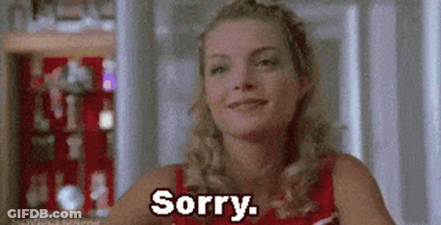 A Woman Is Smiling And Saying Sorry While Wearing A Cheerleading Uniform . GIF