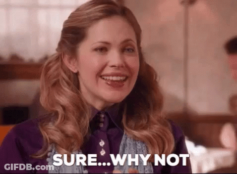 A Woman Is Smiling And Saying `` Sure Why Not '' . GIF