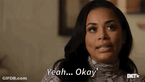 A Woman Is Smiling And Saying `` Yeah ... Okay '' While Sitting On A Couch . GIF