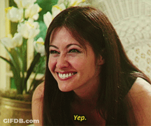 A Woman Is Smiling And Says Yep In Yellow GIF