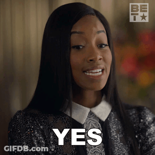 A Woman Is Smiling And Says Yes In Front Of Her Face GIF