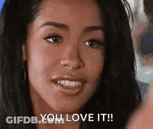 A Woman Is Smiling And Says `` You Love It '' . GIF