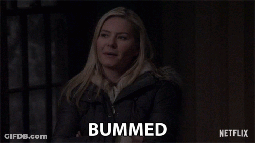 A Woman Is Smiling And The Word Bummed Is On The Screen Behind Her GIF