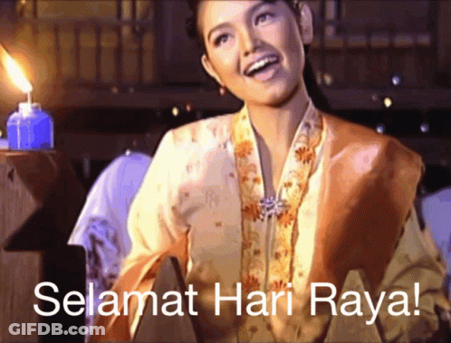 A Woman Is Smiling In Front Of A Candle And The Words Selamat Hari Raya GIF