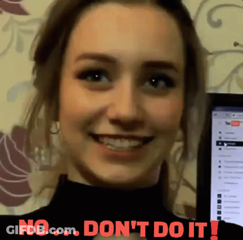 A Woman Is Smiling In Front Of A Computer Screen That Says No ... Don 'T Do It ! GIF