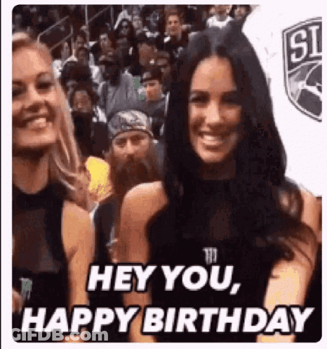 A Woman Is Smiling In Front Of A Crowd And Says `` Hey You , Happy Birthday '' While Standing Next To Another Woman . GIF
