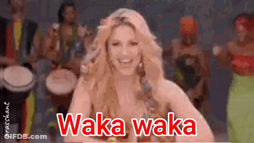 A Woman Is Smiling In Front Of A Group Of Drummers And The Words Waka Waka Are On The Screen GIF