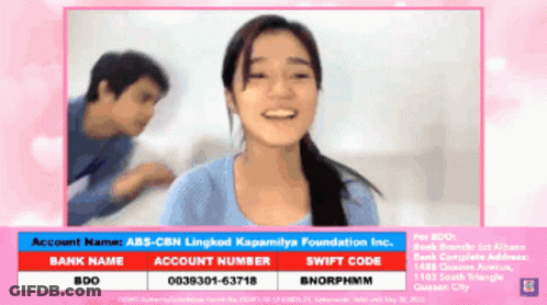 A Woman Is Smiling In Front Of A Man And A Sign That Says Account Name Abs-Cbn Lingkod Kapamilya Foundation Inc GIF