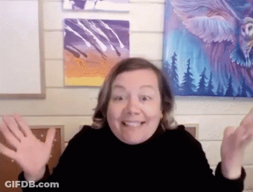 A Woman Is Smiling In Front Of A Painting Of An Eagle On A Wall GIF
