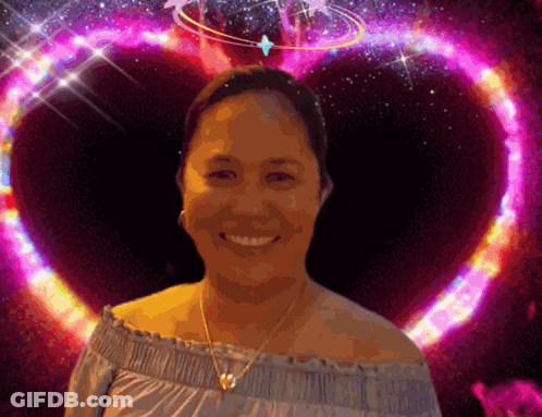 A Woman Is Smiling In Front Of A Purple Heart GIF