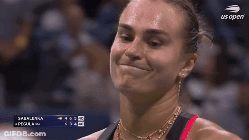 A Woman Is Smiling In Front Of A Scoreboard That Says Sabalenka On It GIF
