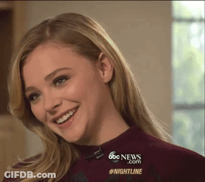 A Woman Is Smiling In Front Of A Screen That Says Abc News.com #Nightline GIF