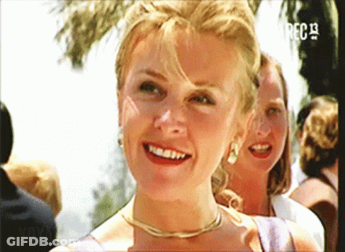 A Woman Is Smiling In Front Of A Screen That Says ' Rec 13 ' GIF