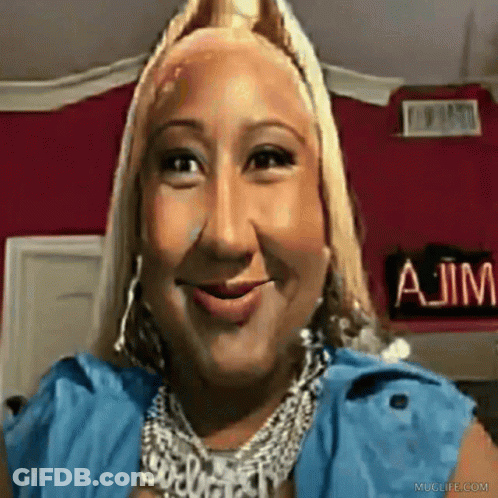 A Woman Is Smiling In Front Of A Sign That Says A Jim GIF