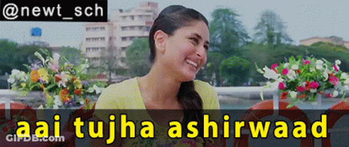 A Woman Is Smiling In Front Of A Sign That Says Aai Tujha Ashirwaad GIF