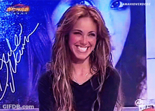 A Woman Is Smiling In Front Of A Sign That Says ' Anahioverdose ' On It GIF