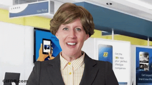 A Woman Is Smiling In Front Of A Sign That Says Cards GIF