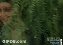 A Woman Is Smiling In Front Of A Tree With The Words Keeping Up With The Kardashians Written On The Bottom GIF