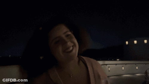 A Woman Is Smiling In The Dark And The Name Shagarita Is On The Bottom Right GIF