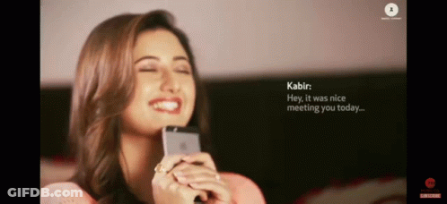 A Woman Is Smiling While Holding A Cell Phone And Says Kabir Hey It Was Nice Meeting You Today ... GIF