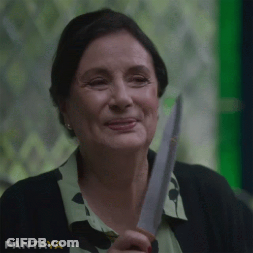 A Woman Is Smiling While Holding A Knife In Front Of A Green Background That Says Pantaya On It GIF