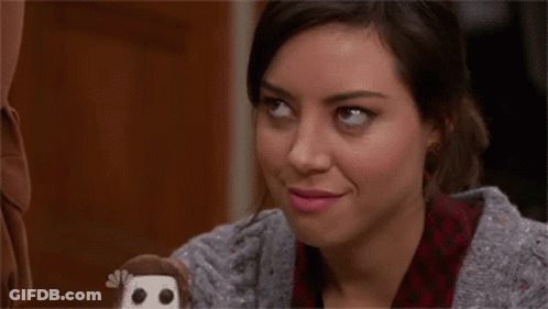 A Woman Is Smiling While Holding A Stuffed Monkey With The Letter B On It GIF