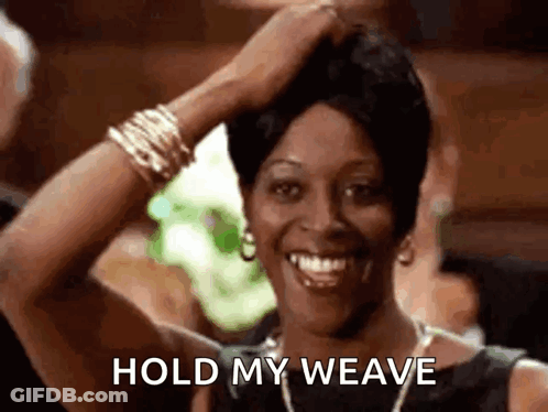 A Woman Is Smiling While Holding Her Hair In Her Hand And Says `` Hold My Weave '' . GIF