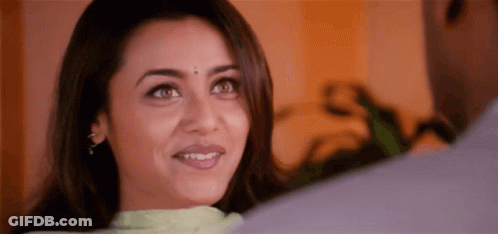 A Woman Is Smiling While Looking At A Man . GIF