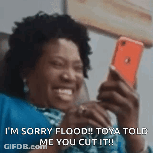 A Woman Is Smiling While Looking At Her Cell Phone And Says I 'M Sorry Flood ! GIF