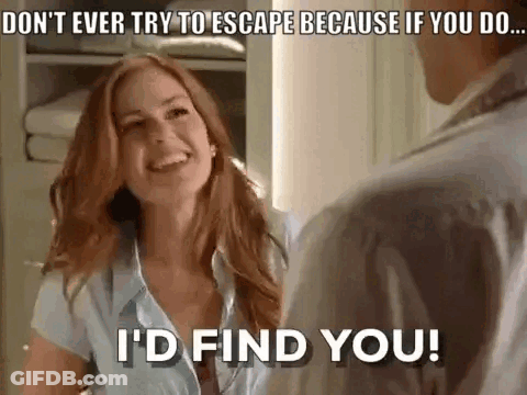 A Woman Is Smiling While Talking To A Man In A Room . GIF