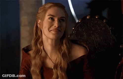 A Woman Is Smiling With Her Eyes Closed While Sitting In A Chair . GIF