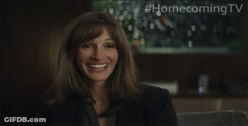 A Woman Is Smiling With #Homecomingtv Written Above Her GIF