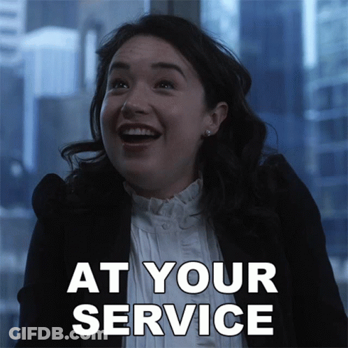 A Woman Is Smiling With The Words At Your Service Written Below Her GIF