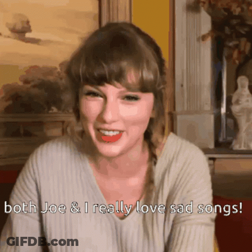 A Woman Is Smiling With The Words Both Joe And I Really Love Sad Songs Below Her GIF