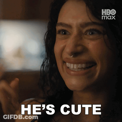 A Woman Is Smiling With The Words He 'S Cute Written Below Her GIF