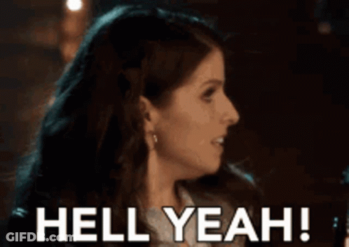 A Woman Is Smiling With The Words Hell Yeah Behind Her GIF