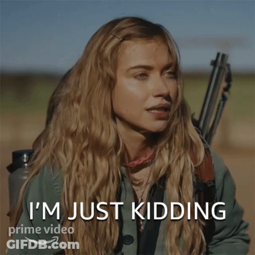 A Woman Is Smiling With The Words I 'M Just Kidding GIF