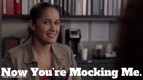 A Woman Is Smiling With The Words Now You 'Re Mocking Me GIF