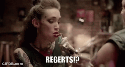A Woman Is Smoking A Cigarette And Says Regerts GIF