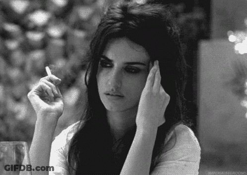 A Woman Is Smoking A Cigarette In A Black And White Photo With The Caption Imperial Bedrooms GIF